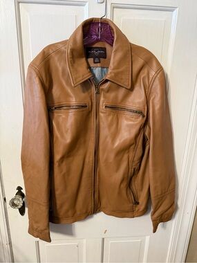 Black Brown 1826 tan leather jacket with a zippered front and chest pockets.